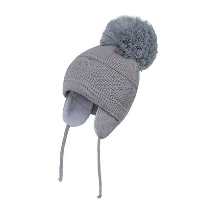 Bebé cálido tejido con pom-pom grande 