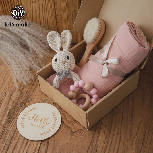 Hagamos el juego de regalos para bebés: elementos esenciales reflexivos en una caja adorable